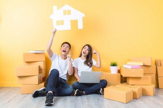 young-couple-moving-into-their-new-home_1150-15934